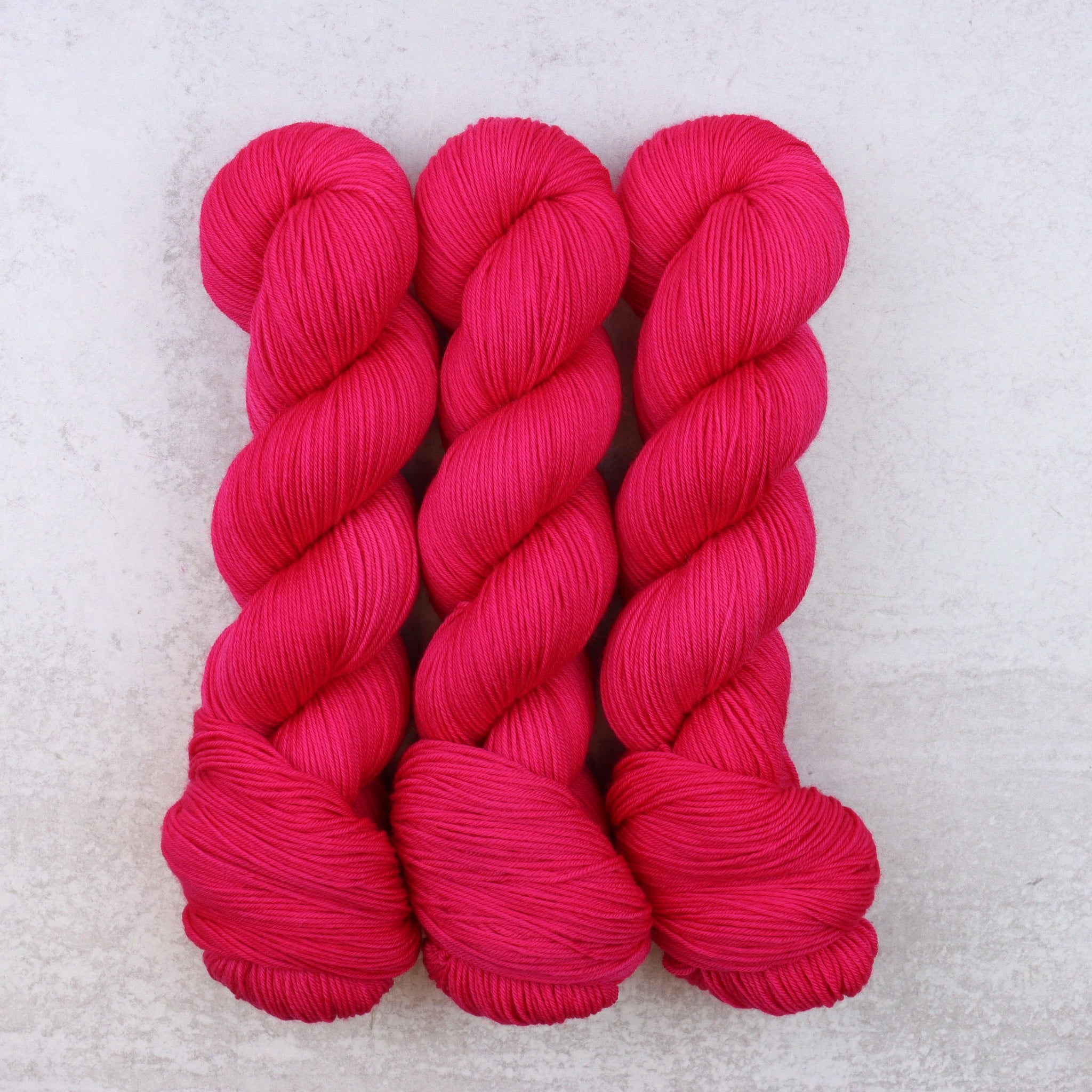 A Bright Fuchsia Semi Solid hand dyed yarn.