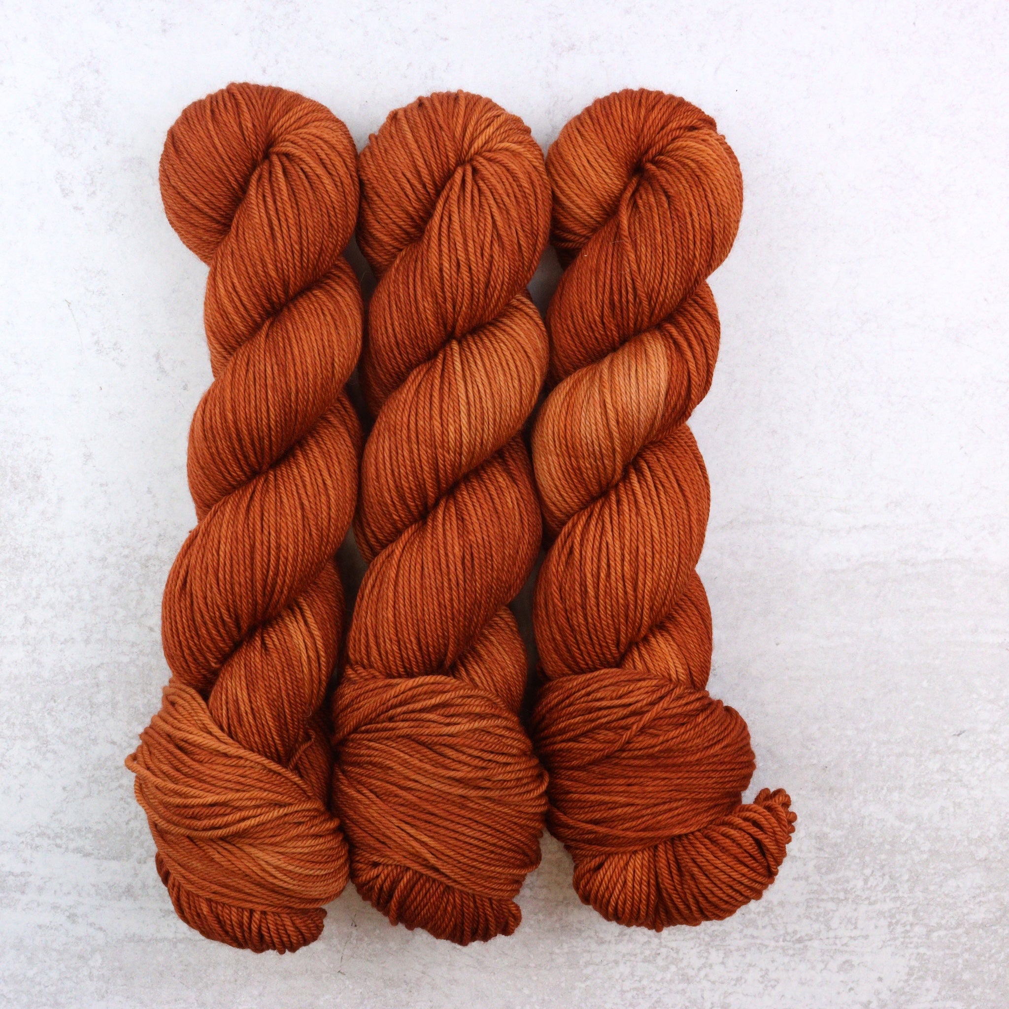 Hand Dyed Yarn named Caramel, a semi solid rusty hue.