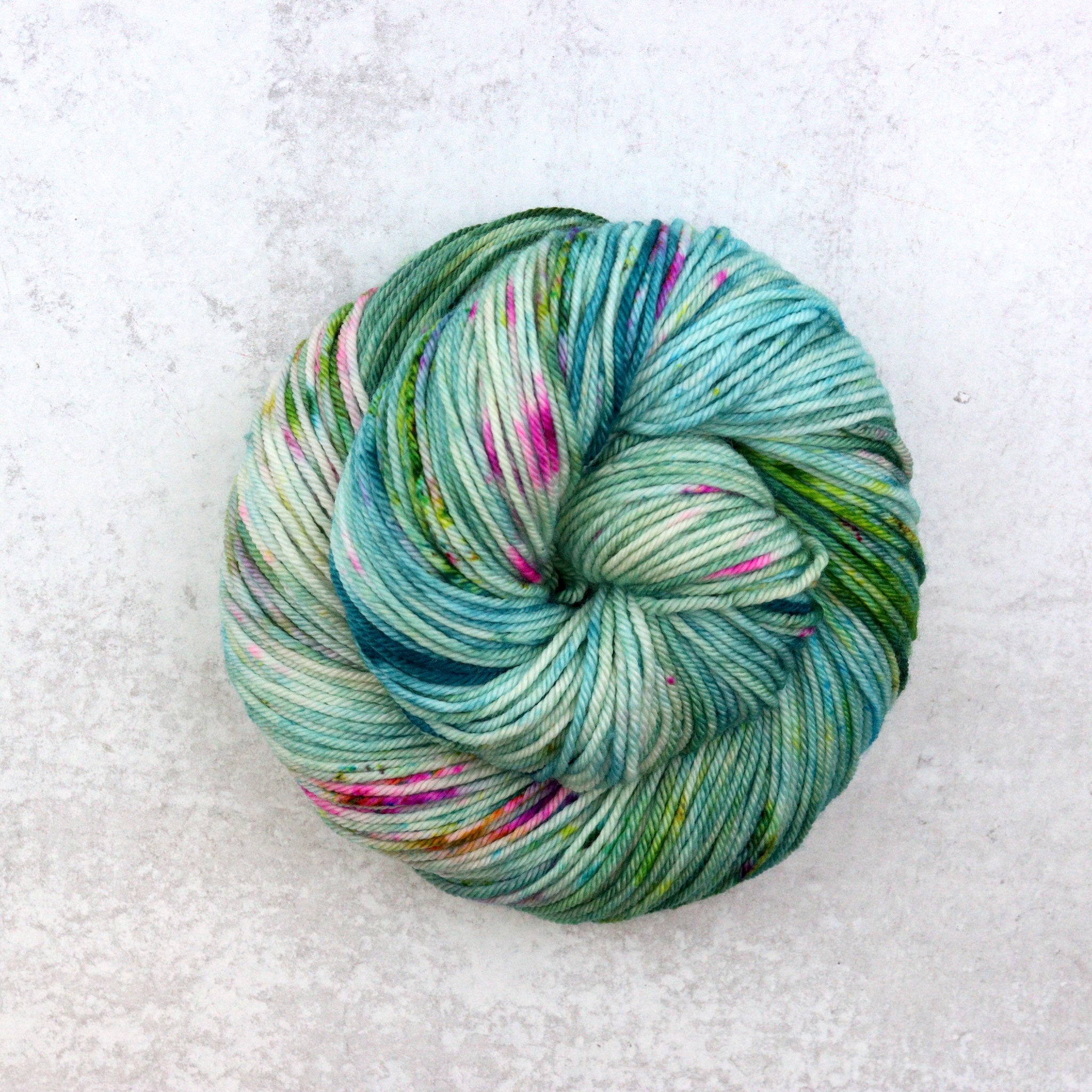 Multi colored skeins featuring green, pink and purple.