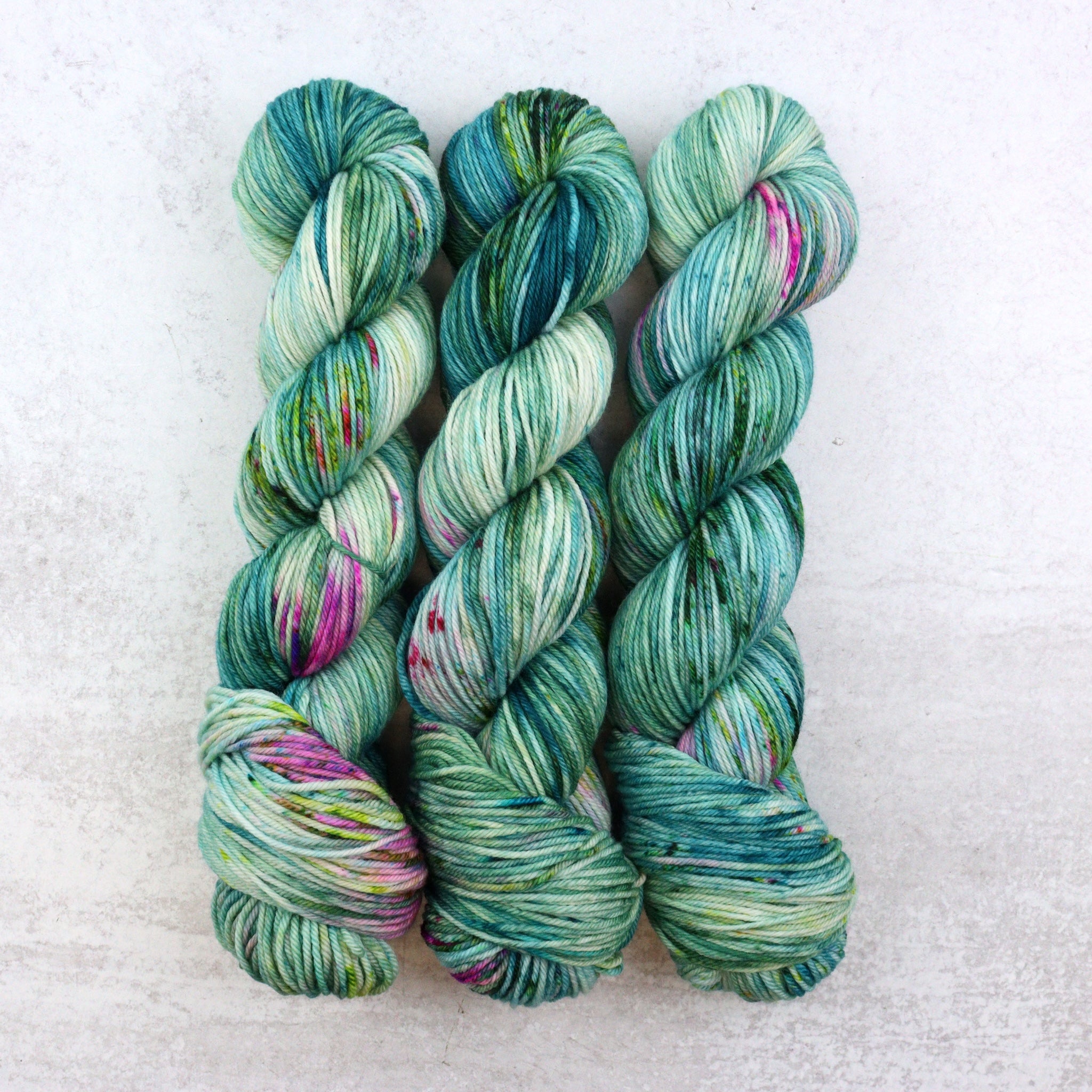 Multi colored skeins featuring green, pink and purple.