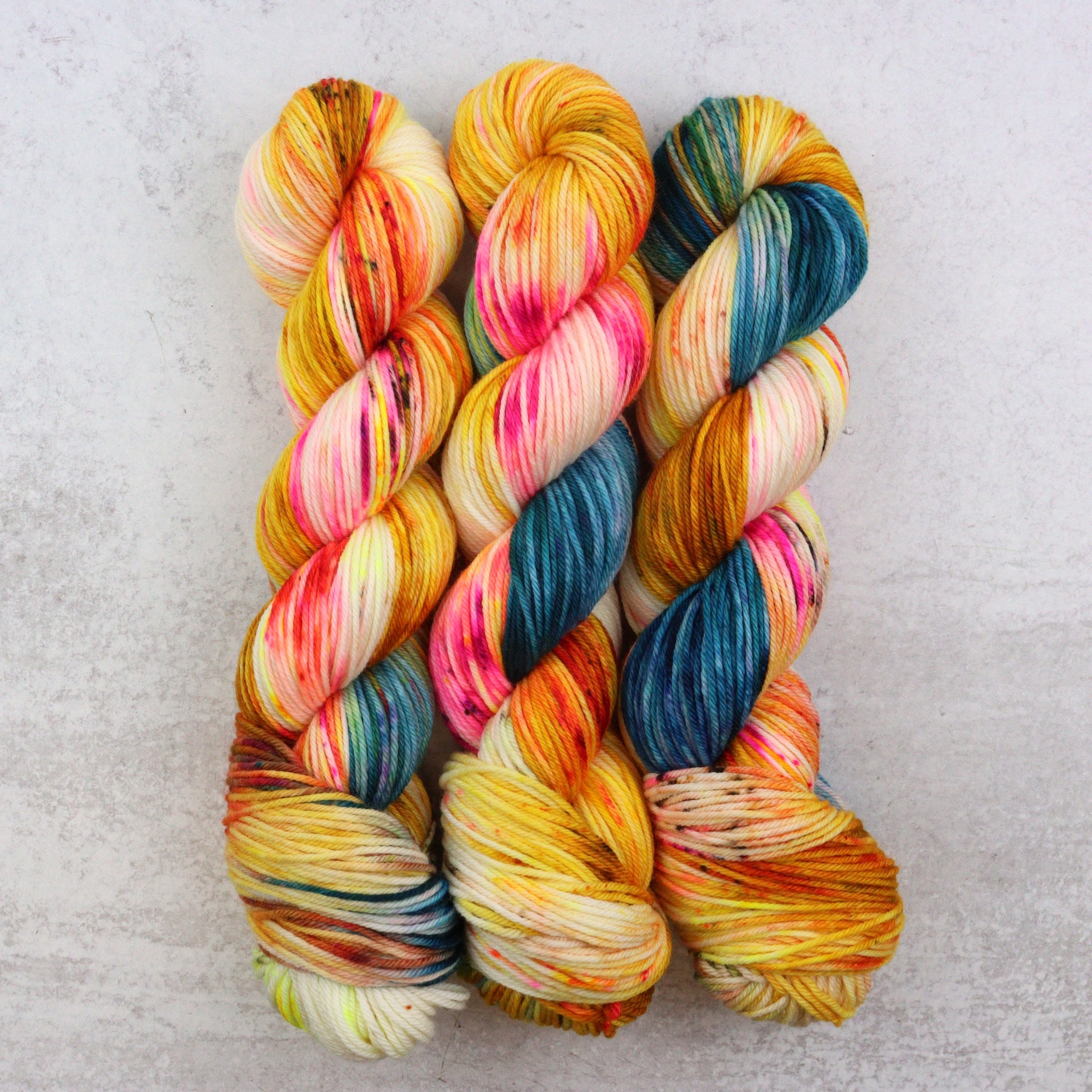 Multicolored yarn skeins on a light gray background