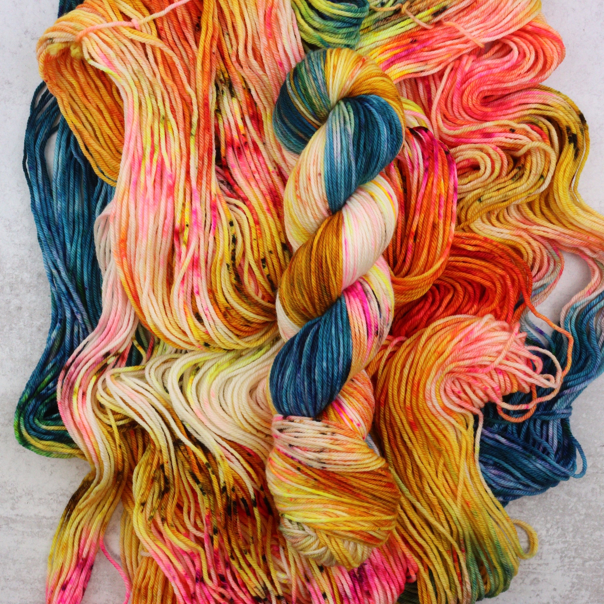 Multicolored yarn skeins on a textured surface