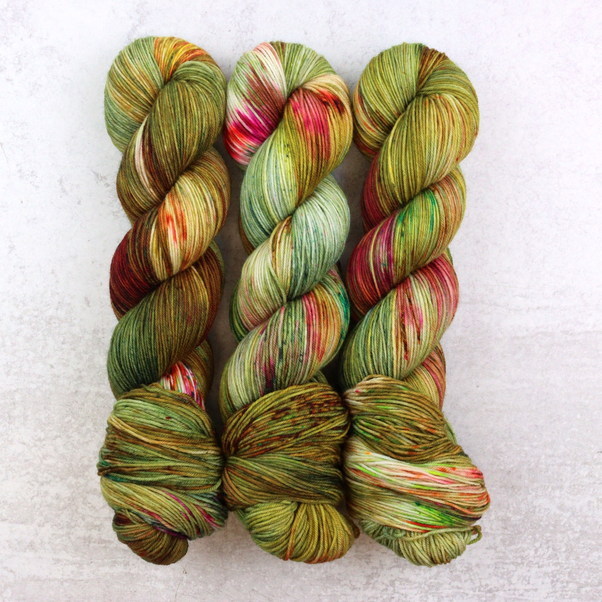 hand dyed yarn in green gold, pink, aqua, brown and orange. 