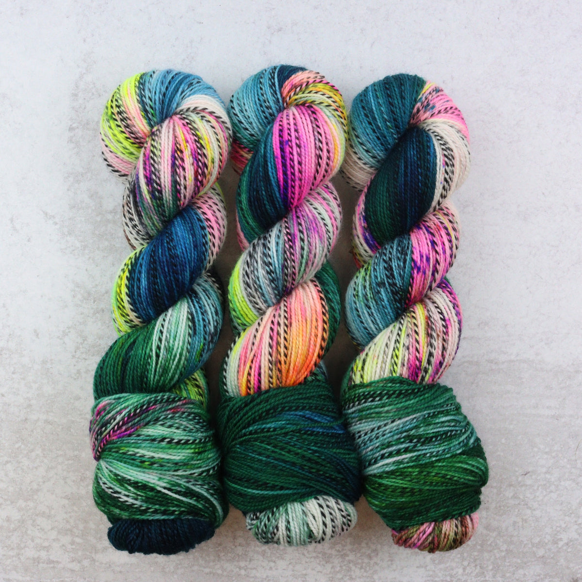 Hand dyed skeins featuring blue, green, orange, yellow and pink.