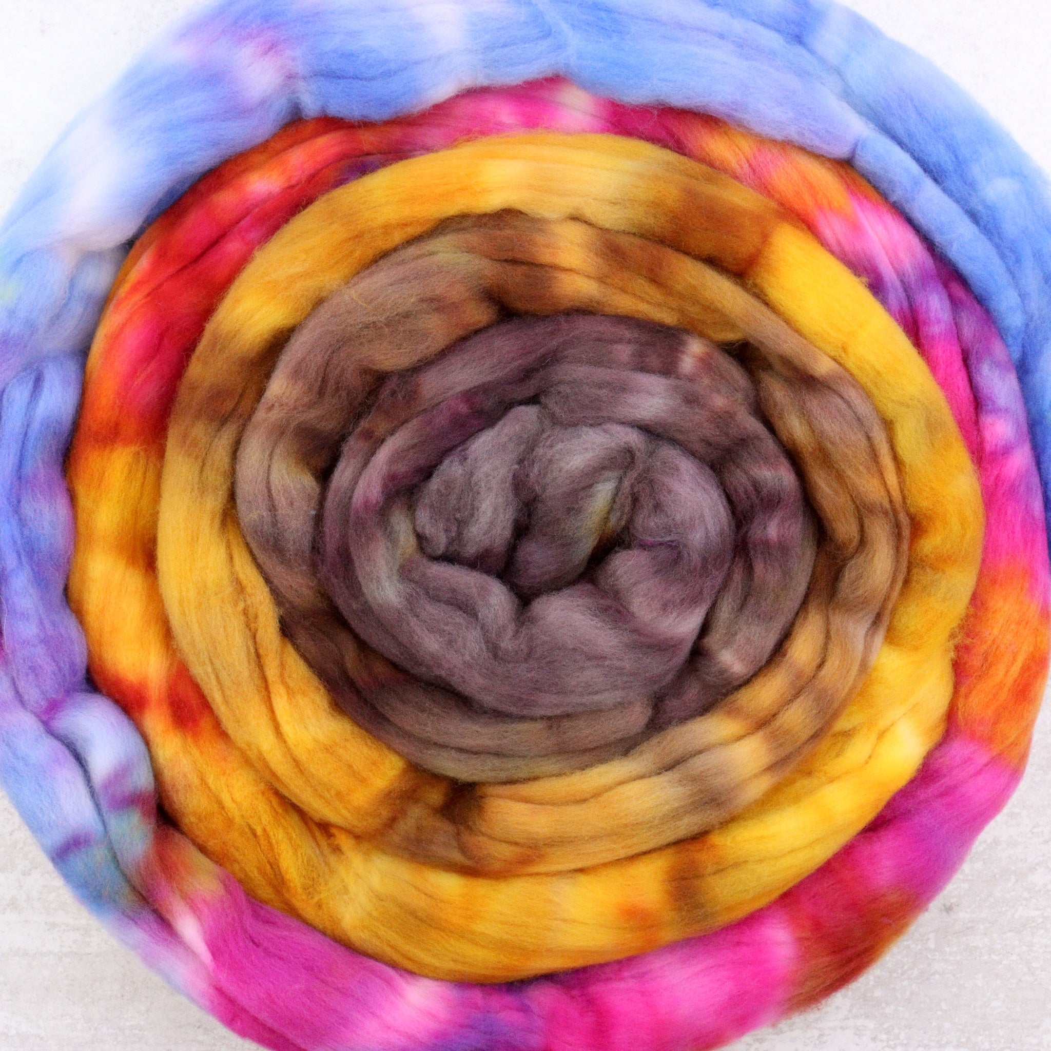 Hand dyed rambouillet spinning fiber in pink, blue, golden yellow and brown.