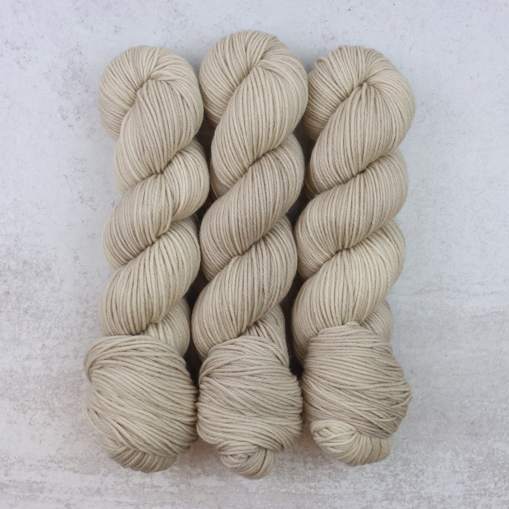 Hand dyed yarn in a warm toned sand color. 