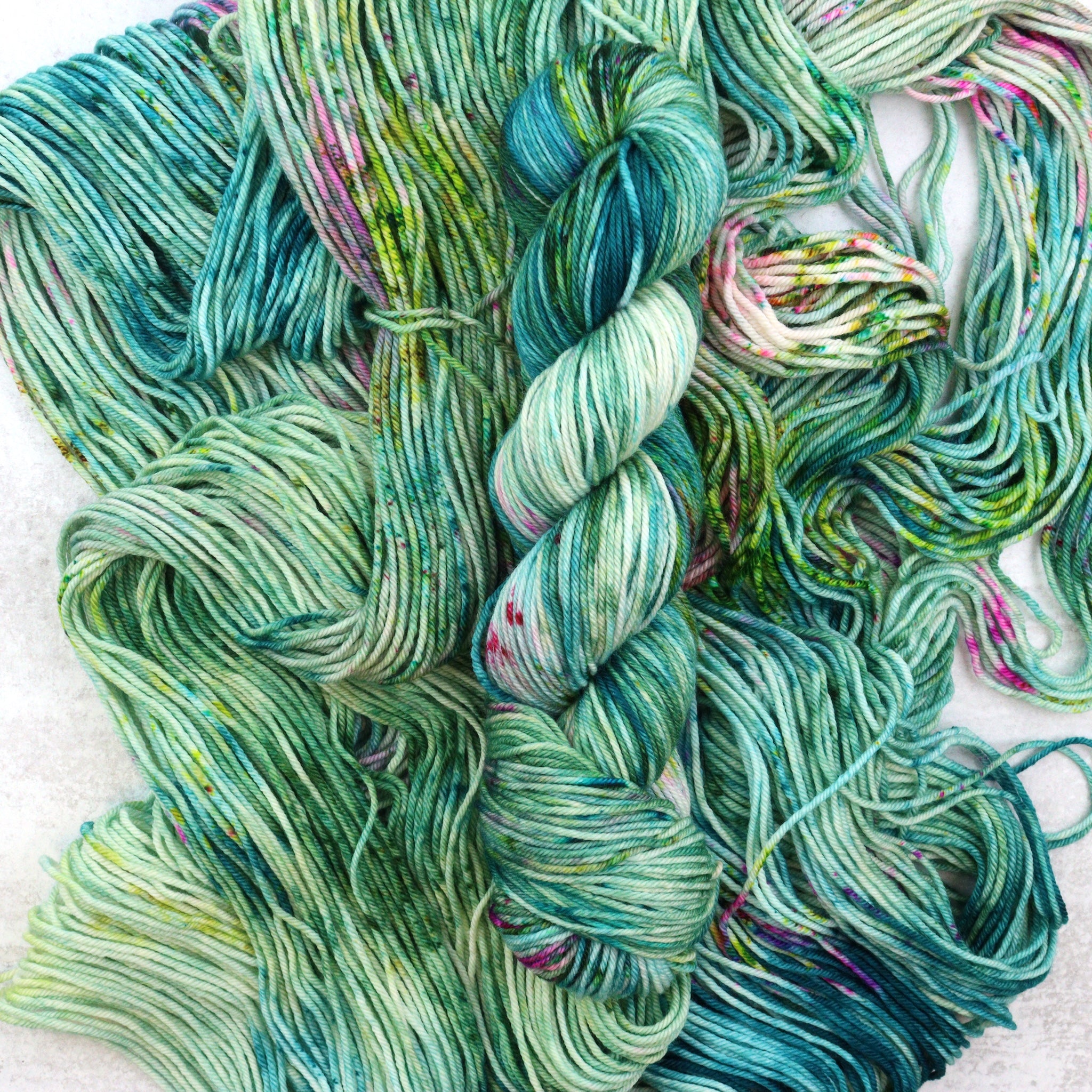 Multi colored skeins featuring green, pink and purple.