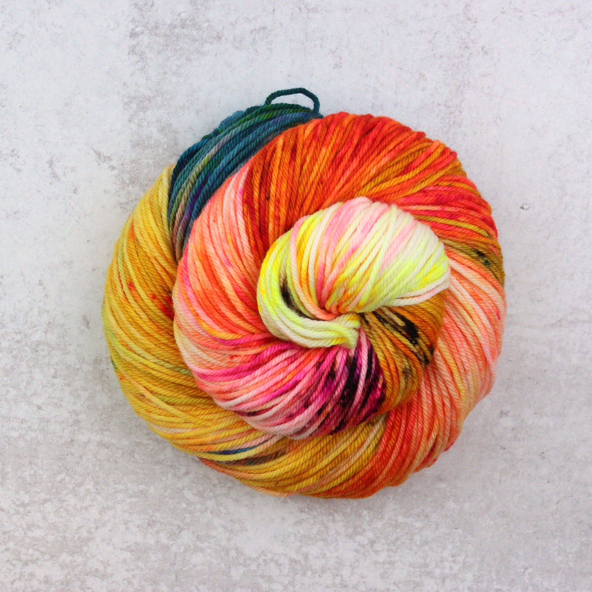 Multicolored skein of yarn on a light gray background